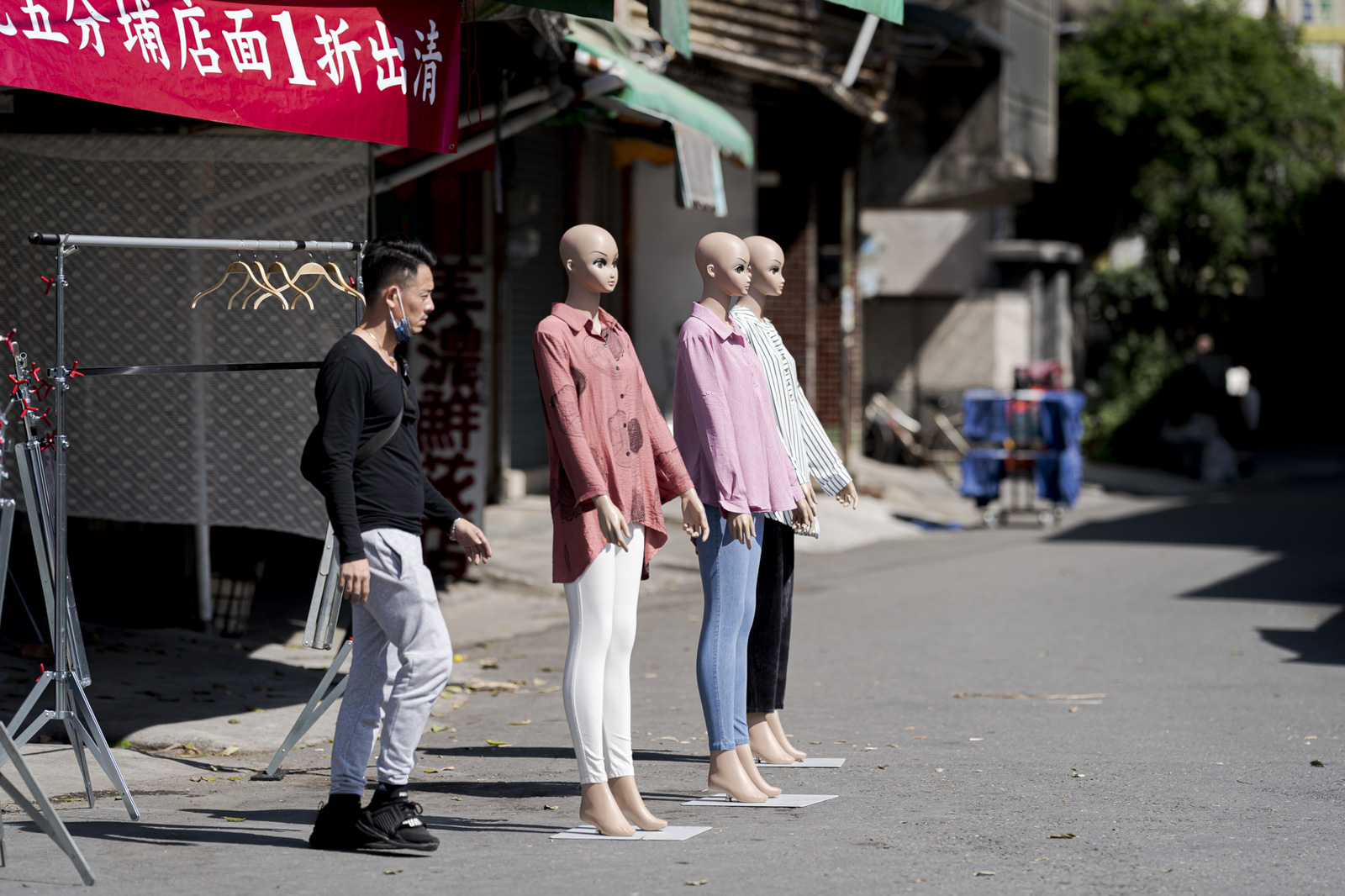 市場前站立的人與三座人形模特
