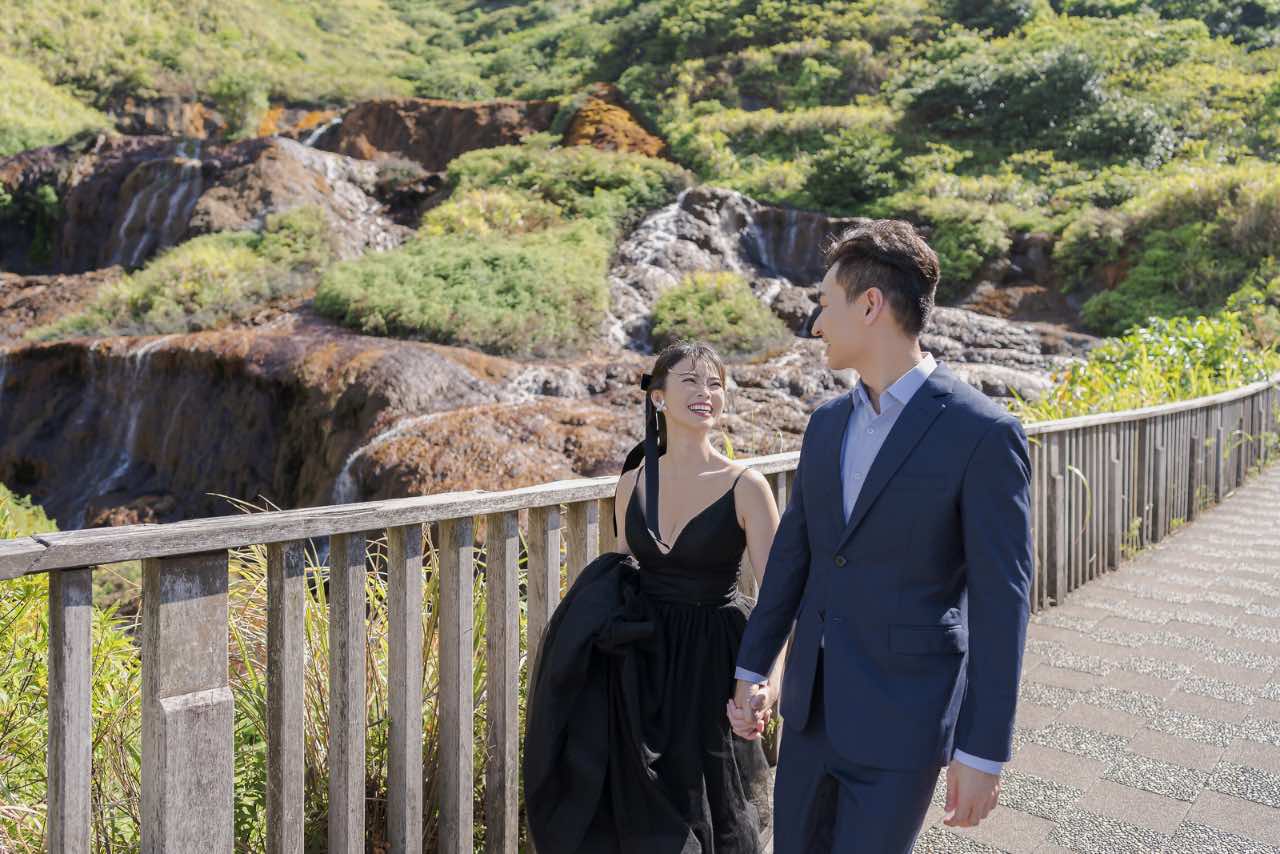 新人在九份黃金瀑布旁散步拍攝婚紗,氛圍輕鬆自然